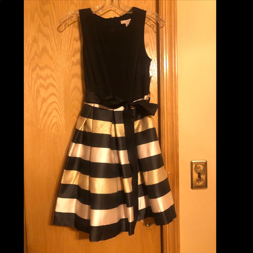 Black, gold, and white fit and flare dress